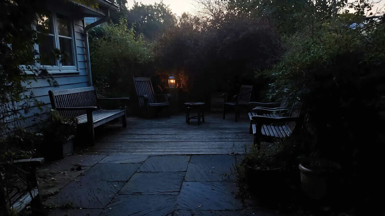 A patio at night with insufficient lighting, limiting usability and creating safety concerns.