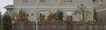 Backyard patio exposed to second-story neighbor windows with overlay showing downward sightlines over a standard privacy fence
